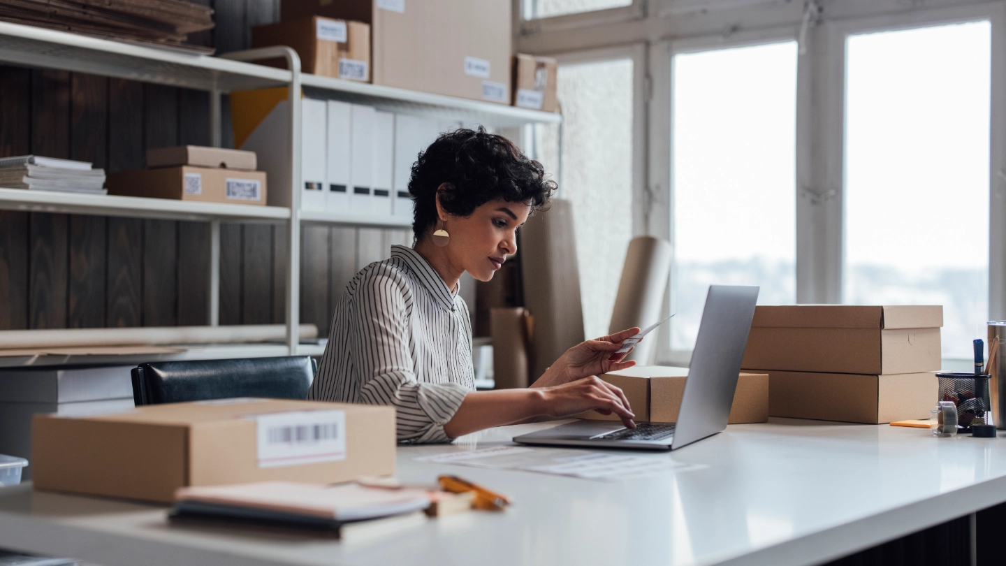 Mixed race woman in an office surrounded by boxes Mixed race woman in an office surrounded by boxes