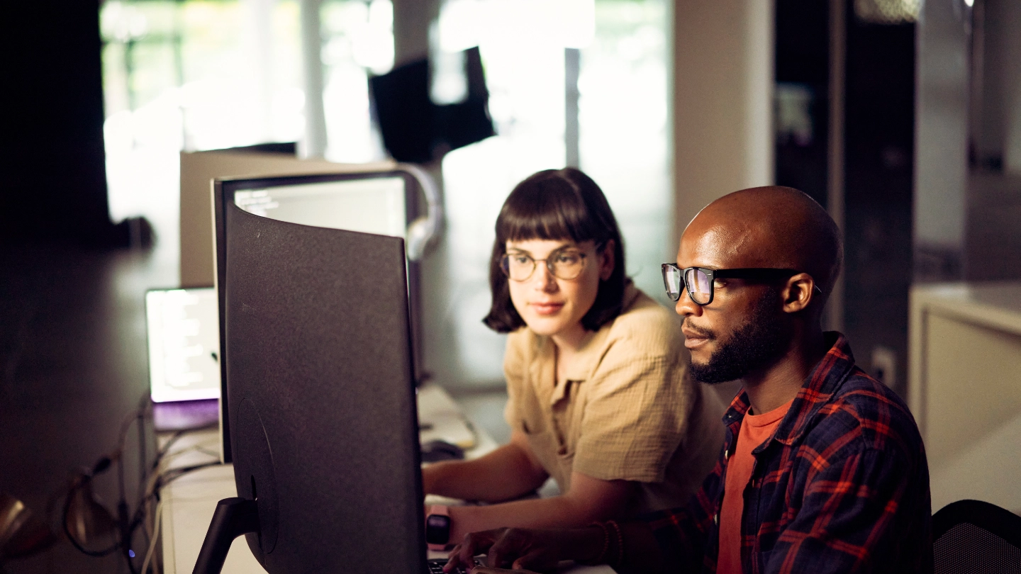 Male and female compute analysts working in front of computer Male and female compute analysts working in front of computer